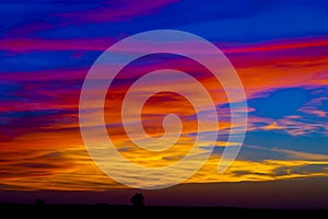 Red clouds over a farm