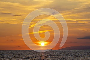 Red Clouds Sunset Above Water. Seascape in Early Morning, Sunrise Over Sea. Nature Landscape. Bright red Sunset