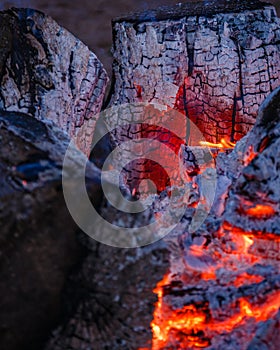 Red coal and fire flames in the middle of the campfire