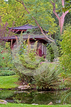 Red coated Asian style hut amidst a Japanese Garden in Leverkusen, Germany