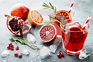 Red cocktail with blood orange and pomegranate. Refreshing summer drink. Holiday aperitif for Christmas party.