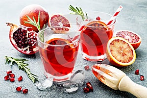 Red cocktail with blood orange and pomegranate. Refreshing summer drink. Holiday aperitif for Christmas party.