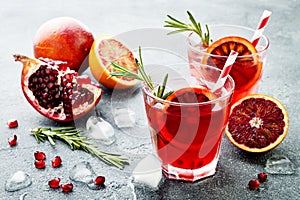 Red cocktail with blood orange and pomegranate. Refreshing summer drink. Holiday aperitif for Christmas party.