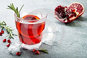 Red cocktail with blood orange and pomegranate. Refreshing summer drink. Holiday aperitif for Christmas party.