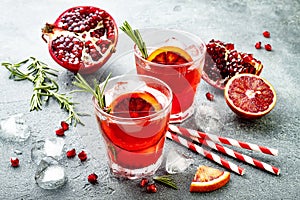 Red cocktail with blood orange and pomegranate. Refreshing summer drink. Holiday aperitif for Christmas party. photo