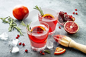 Red cocktail with blood orange and pomegranate. Refreshing summer drink. Holiday aperitif for Christmas party.