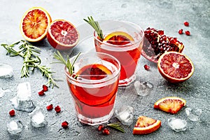 Red cocktail with blood orange and pomegranate. Refreshing summer drink. Holiday aperitif for Christmas party. photo
