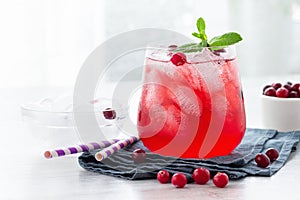 Red cocktail with cranberry, vodka, mint and ice.