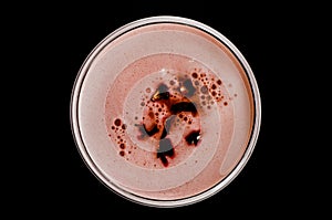 Red cocktail with foam and roses petal seen from above