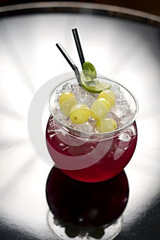 Red cocktail with grapes