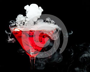 Red cocktail with ice vapor