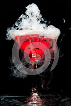 Red cocktail with ice vapor photo