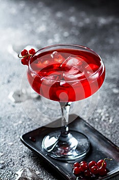 Red cocktail with ice vapor. Cocktail with smoke. Alcohol drink, vodka, ice, party, dry ice.