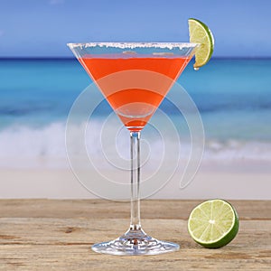 Red cocktail Martini drink on the beach