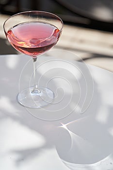 Red cocktail in martini glass with cherry. Exotic alcoholic cocktail