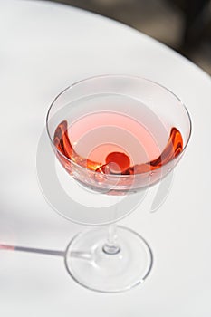 Red cocktail in martini glass with cherry. Exotic cocktail