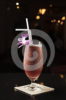 Red cocktail with orchid