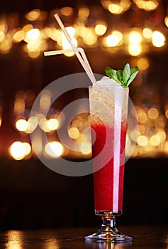 Red cocktail with straws