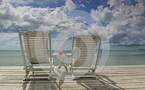 Red cocktail on white table set over ocean