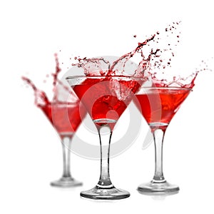 Red cocktails with splash on white