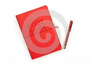 Red Code Book and red pen photo