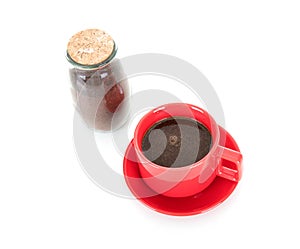 Red coffee cup and a bottle of ground coffee on white background