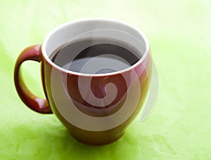 Red Coffee Cup on Green Background