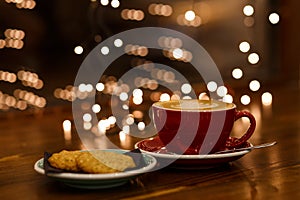 Red coffee cup and green plate with cookies