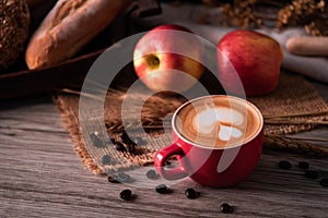 Red coffee glass rests on wood floor. concept still life