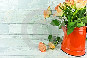 Red coffeepot with a bouquet of roses
