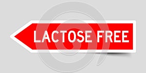 Red arrow sticker with word lactose free on gray background