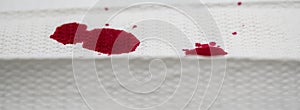 Red color drops on textured towel paper, like nosebleed. Closed up image for crime scene