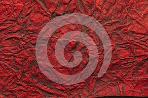 Red color handmade paper of crumple or wrinkle texture with veins and fibers. Useful for background, 3d rendering.