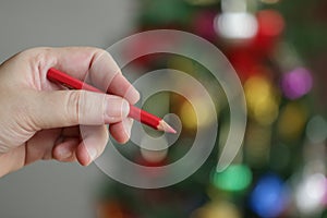 Red color pencil in hand