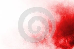 Red color powder explosion on white background.