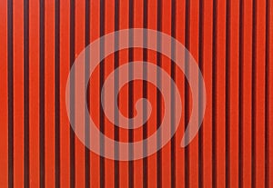 Red color straight line pattern texture. Bright red background with black strips.