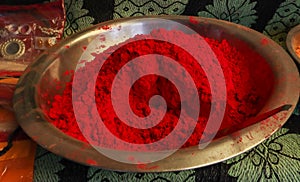 Red color turmeric powder in a steel bowl