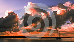 Red colored cumulonimbus cloud, sunset seascape.