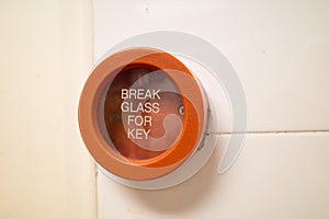 A red colored emergency break glass panel in case of a fire emergency