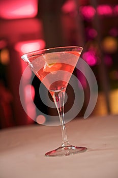 Red colored martini with garnish