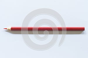 Red colored pencil  One single object, top view, bright tint.