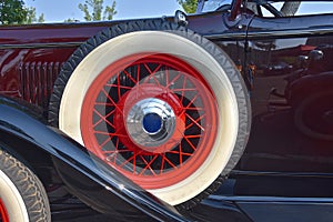 Exterior spare tire on front running board of an old classic car