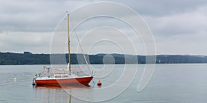 Red colored sailboat at Lake Starnberg