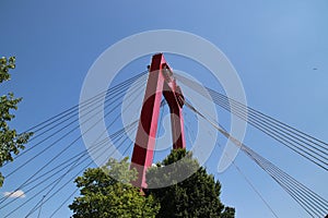 Red colored Willemsbrug over river Nieuwe Maas in Rotterdam, the Netherlands.