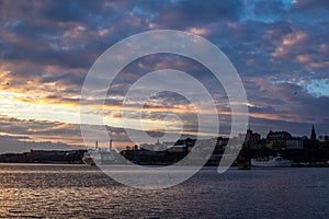 A red, colorful sunrise on the sea in the harbor of  Stockholm in winter  with the backdrop of the Old Town - 6