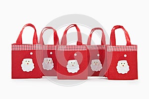 Red colour christmas gifts bags with santaclaus face