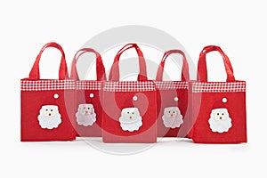 Red colour christmas gifts bags with santaclaus face photo