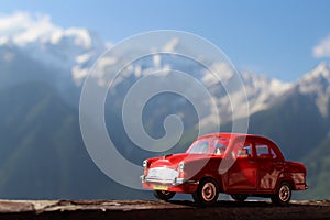 Red colour toy car in hill