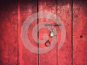 Red colour wooden folding doors with a latch and lock