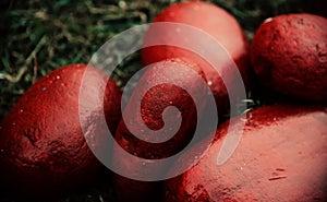 Red colours painted on some round shape stones